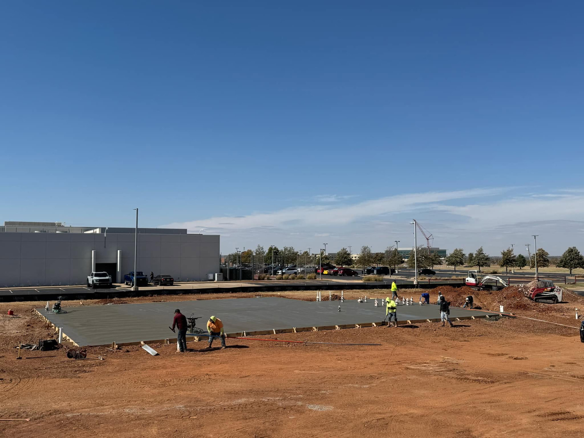 Fuentes Brothers crew finishing a large commercial concrete slab
